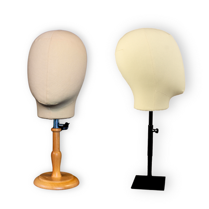 Two mannequin heads with stands on a white background
