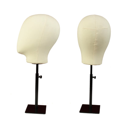 Two mannequin heads on stands with white covers on a white background