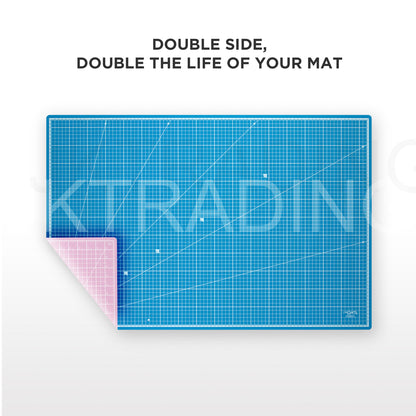 Close-up of a flexible, double-sided A1 PVC cutting mat peeling back to show the dual-color blue and pink reversible surface that extends mat life.