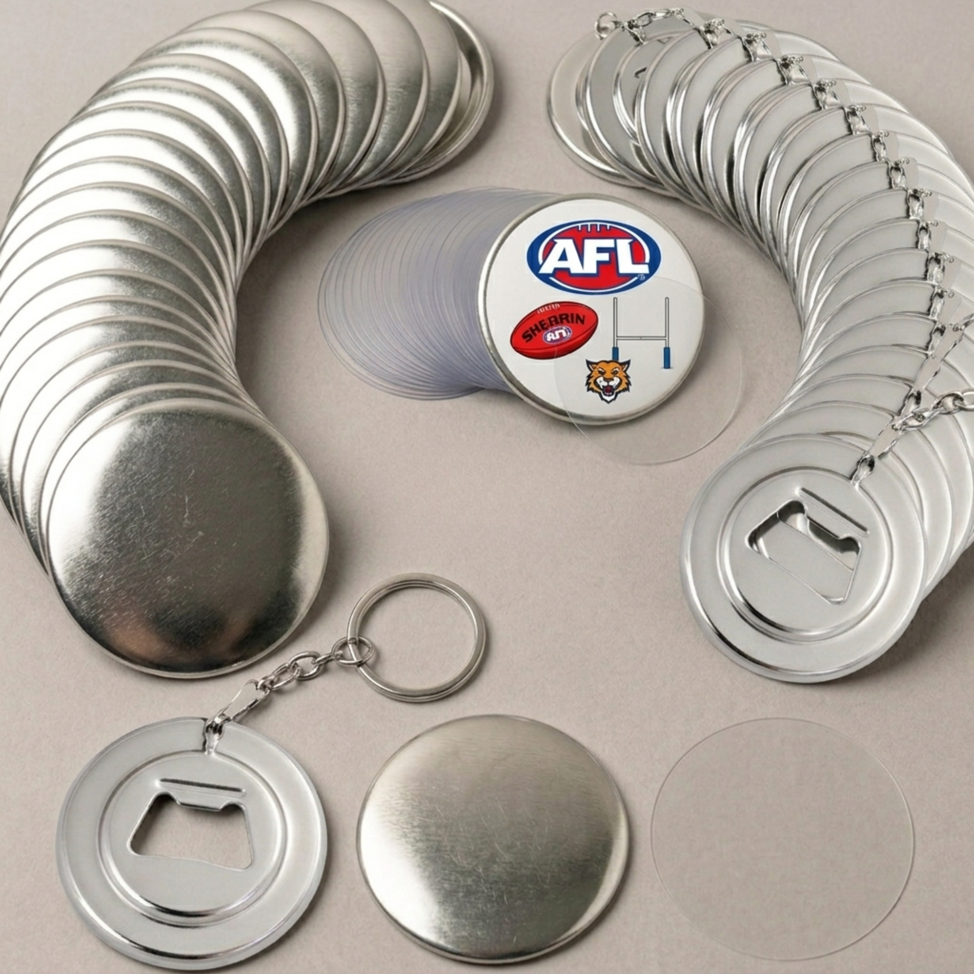 Metal keychain bottle openers with AFL logo on a beige background