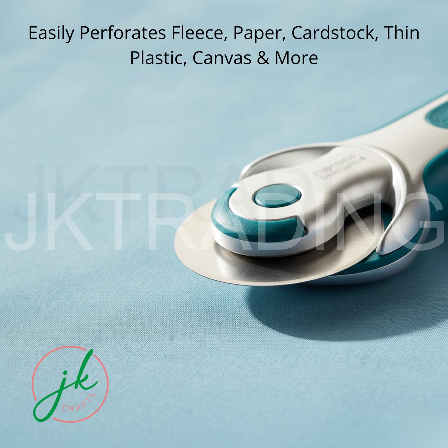 An ergonomic rotary cutter slicing cleanly through heavy canvas and cardboard stock on a grid cutting mat.