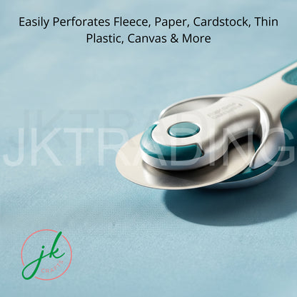 An ergonomic rotary cutter slicing cleanly through heavy canvas and cardboard stock on a grid cutting mat.