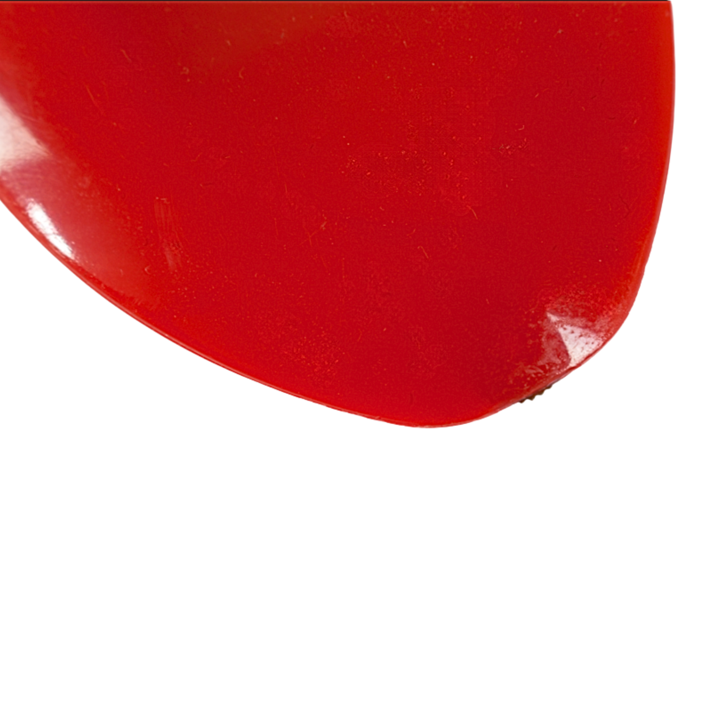 Ultra close-up of the small metal dosing wheel tip on the red tailors chalk tool engineered for smooth powder dispensing.