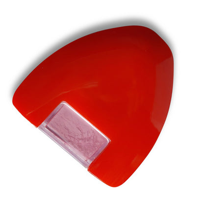 Red plastic powder chalk marker casing containing a pastel pink garment drafting block insert.