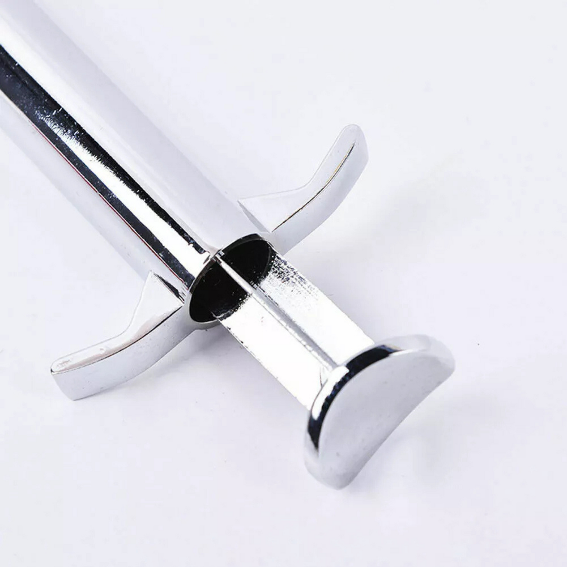 Close-up profile of the durable T-bar handle and plunger on a high-grade stainless steel sculpting gun.