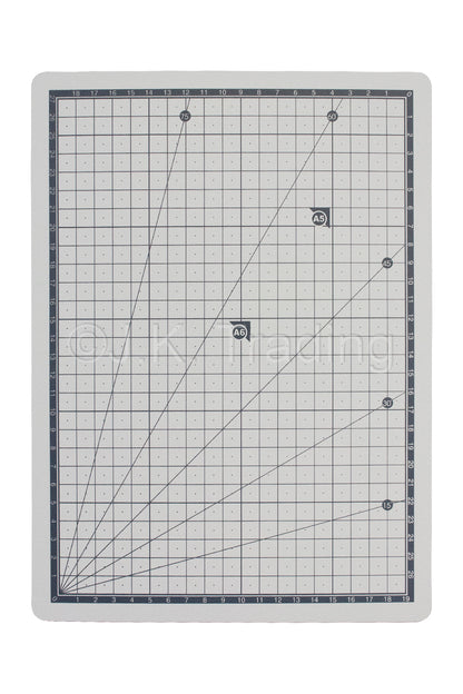Front-facing view of a durable grey 3-ply self-healing A4 cutting mat detailing white metric grid coordinate paths.