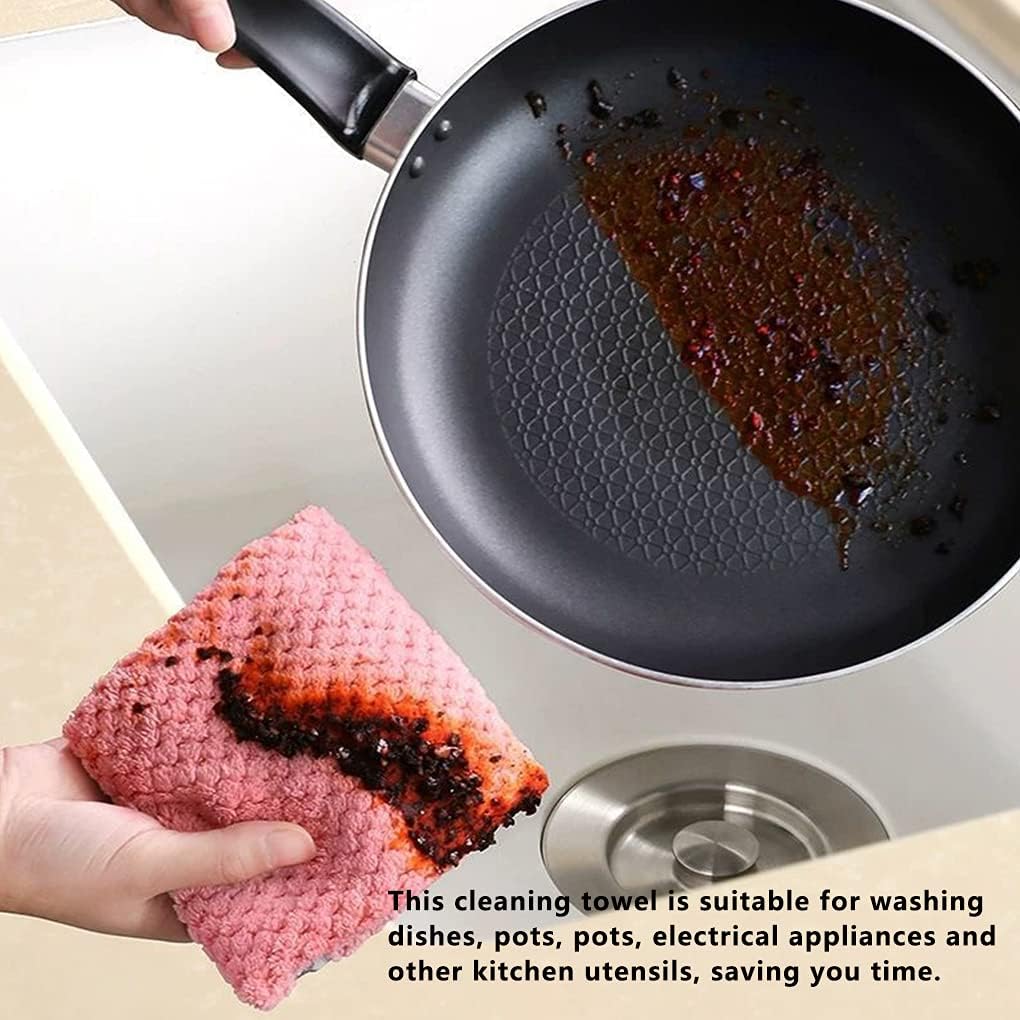 Cleaning a greasy frying pan with a pink cleaning towel over a sink.