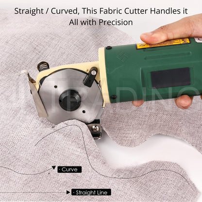 Guided close-up of the electric textile shears tracing an intricate curved pattern line on light grey fabric.