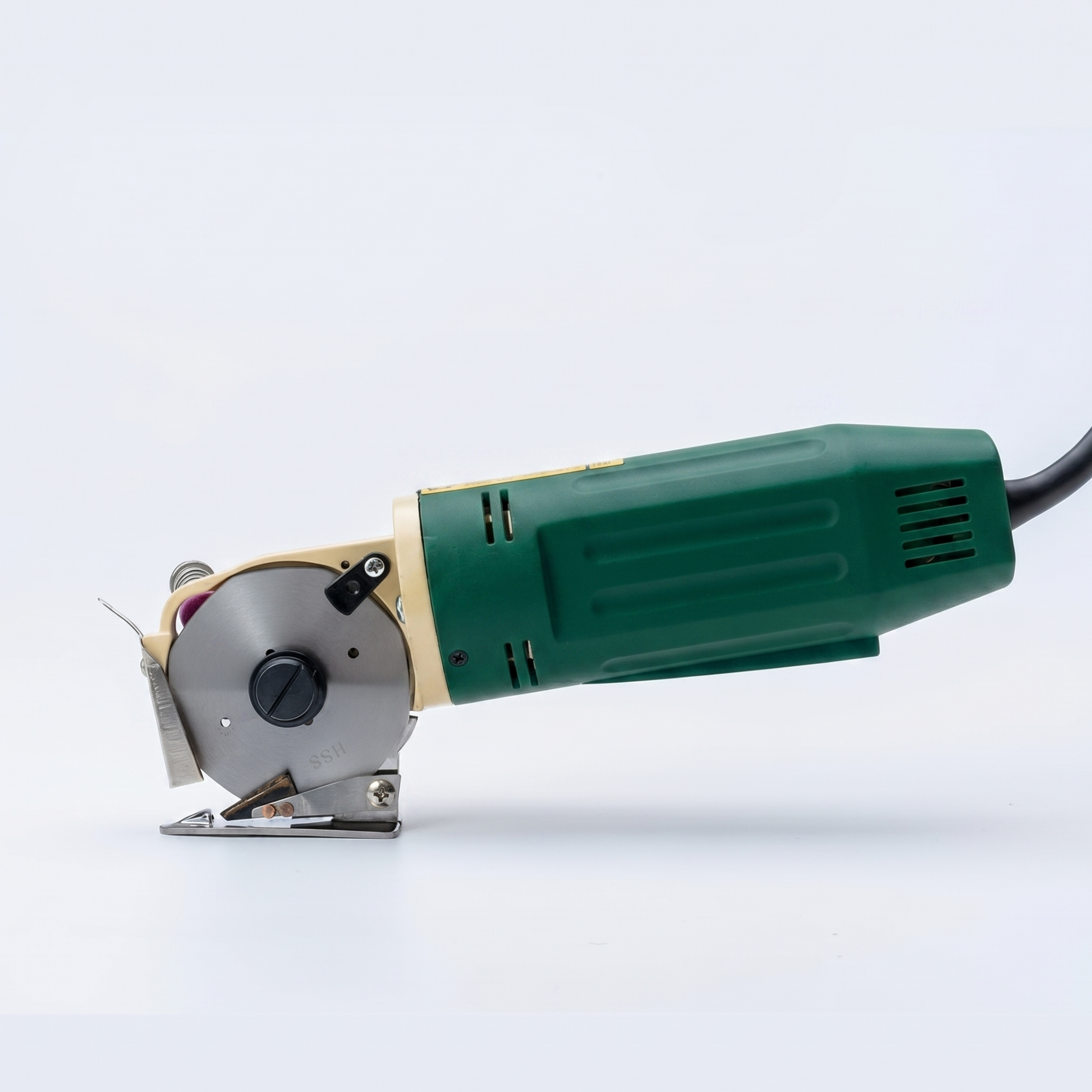Corded green electric rotary fabric cutter machine with a long power cable isolated on a white background.
