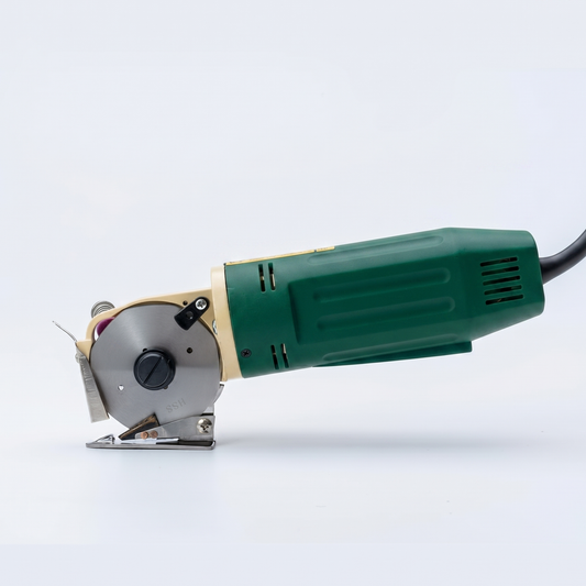 Corded green electric rotary fabric cutter machine with a long power cable isolated on a white background.