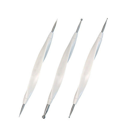 Three white double-sided scoring stylus pens for paper crafting angled on a white backdrop.