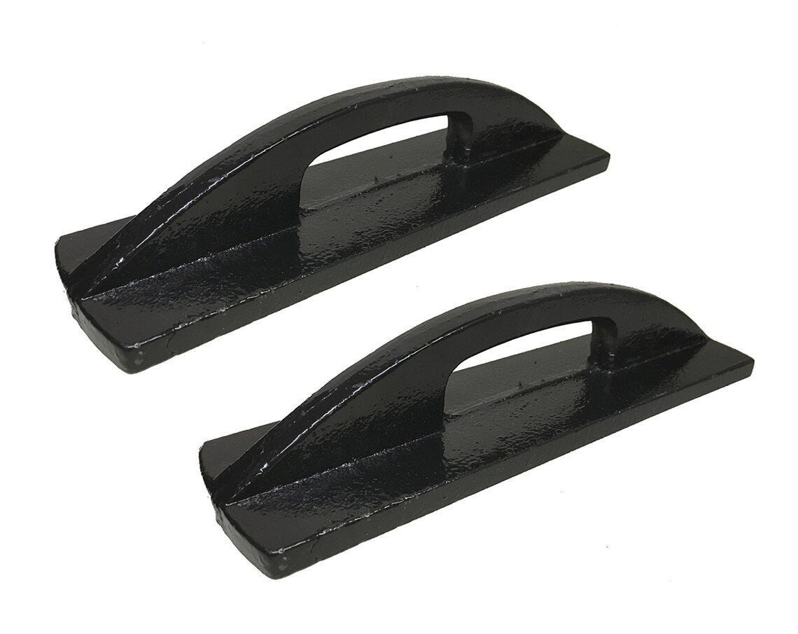 Pair of heavy-duty black iron pattern anchors for sewing arranged at an angle on a white surface.