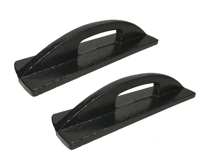 Pair of heavy-duty black iron pattern anchors for sewing arranged at an angle on a white surface.