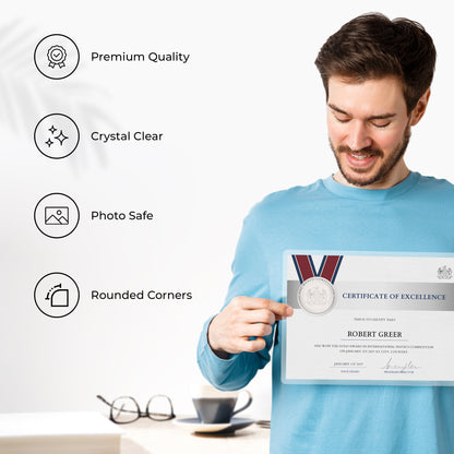 Proud professional holding up a perfectly preserved achievement certificate inside a clear laminating film sheet.