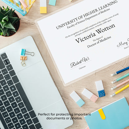 Flat lay perspective of a printed graduation diploma certificate prepared for thermal lamination on a desk workspace.