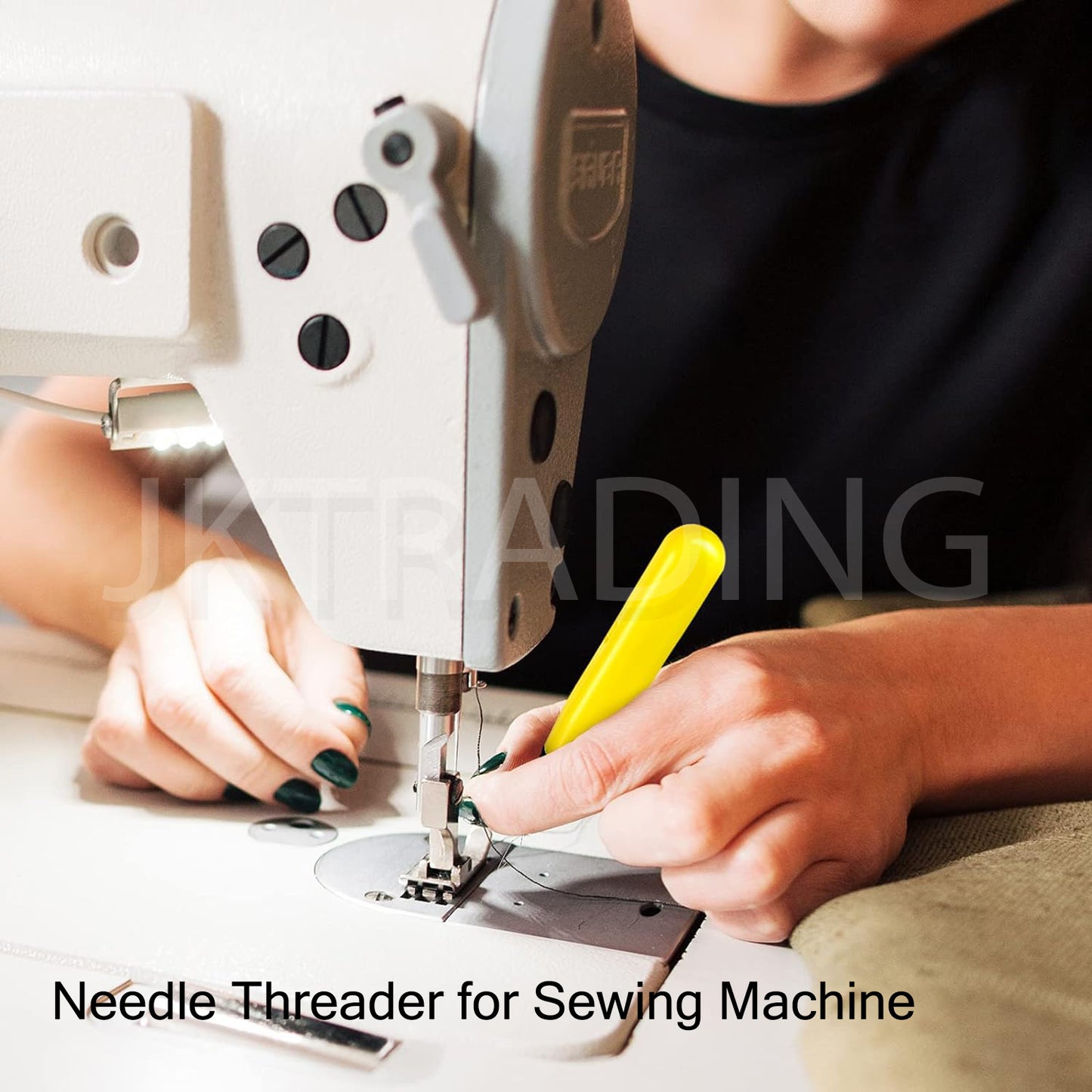 Tailor utilizing the LED lighted wire loops to effortlessly thread a needle directly on a mechanical home sewing machine.