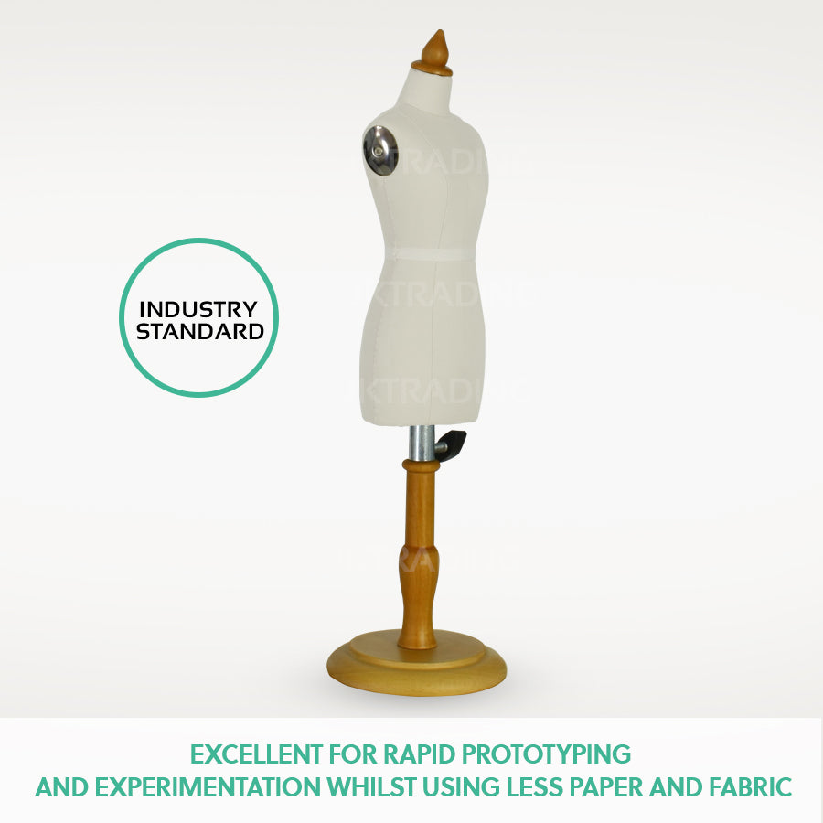 Three-quarter profile view of the miniature female trousers dress form with premium linen fabric on a wood stand.