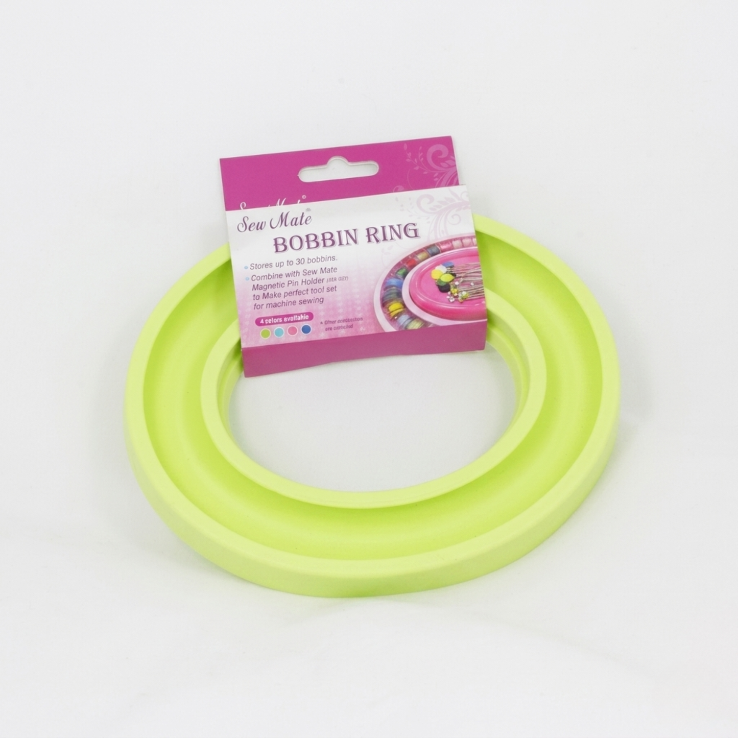 Green bobbin ring with pink packaging on a white background