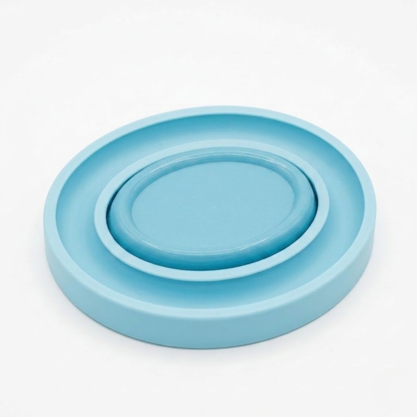 Light blue oval bobbin ring holder with a magnetic pin holder on a white background