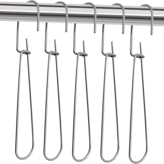Five heavy-duty all-metal pattern hooks neatly lined up hanging on a studio garment rail rod.