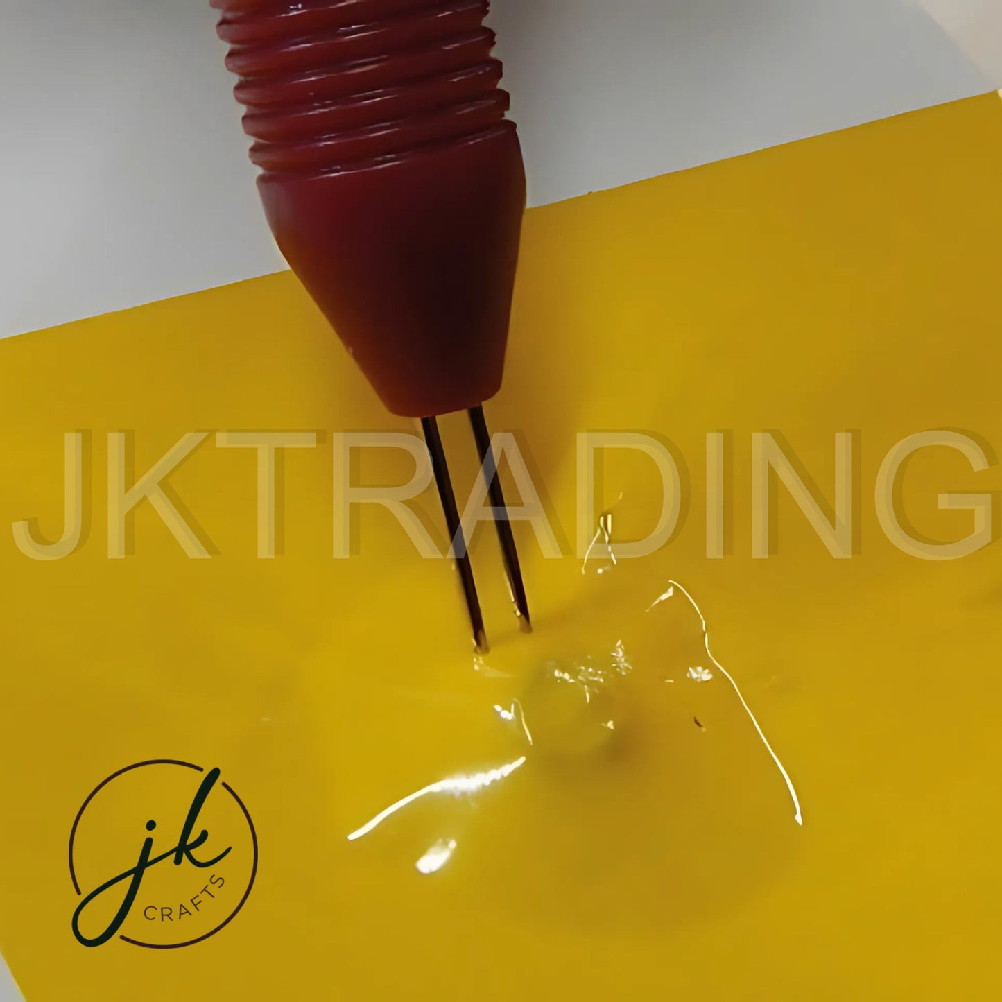 Close-up demonstration of the 2-pin needle tip perforating a crisp decorative line into thick yellow craft paper.