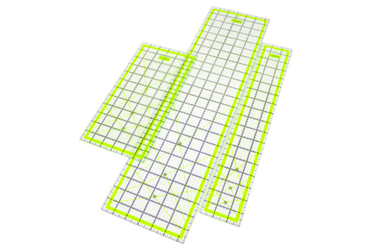 3 rectangular clear acrylic patchworking grid rulers with high-visibility neon yellow edge highlights isolated on a white background.