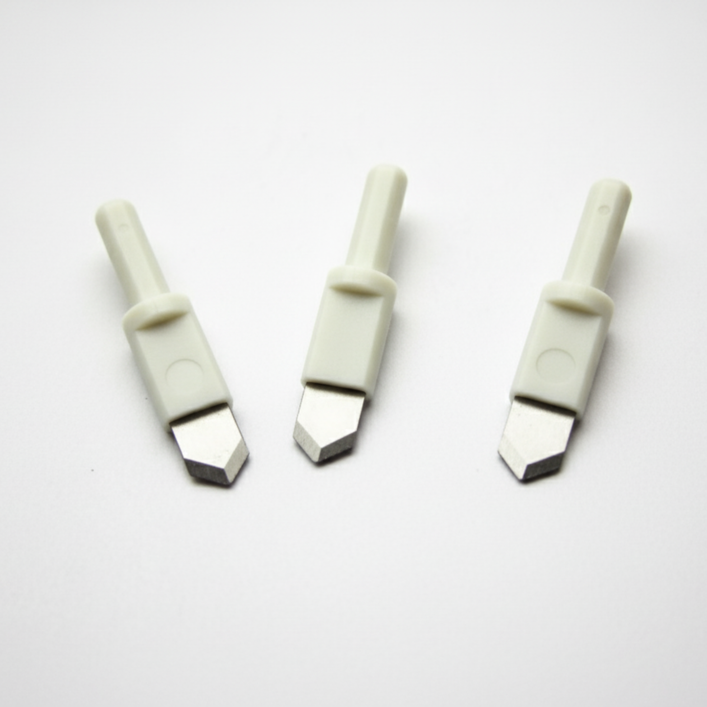 Three ultra-sharp replacement blades with white plastic safety shafts for a round circle compass paper cutter.