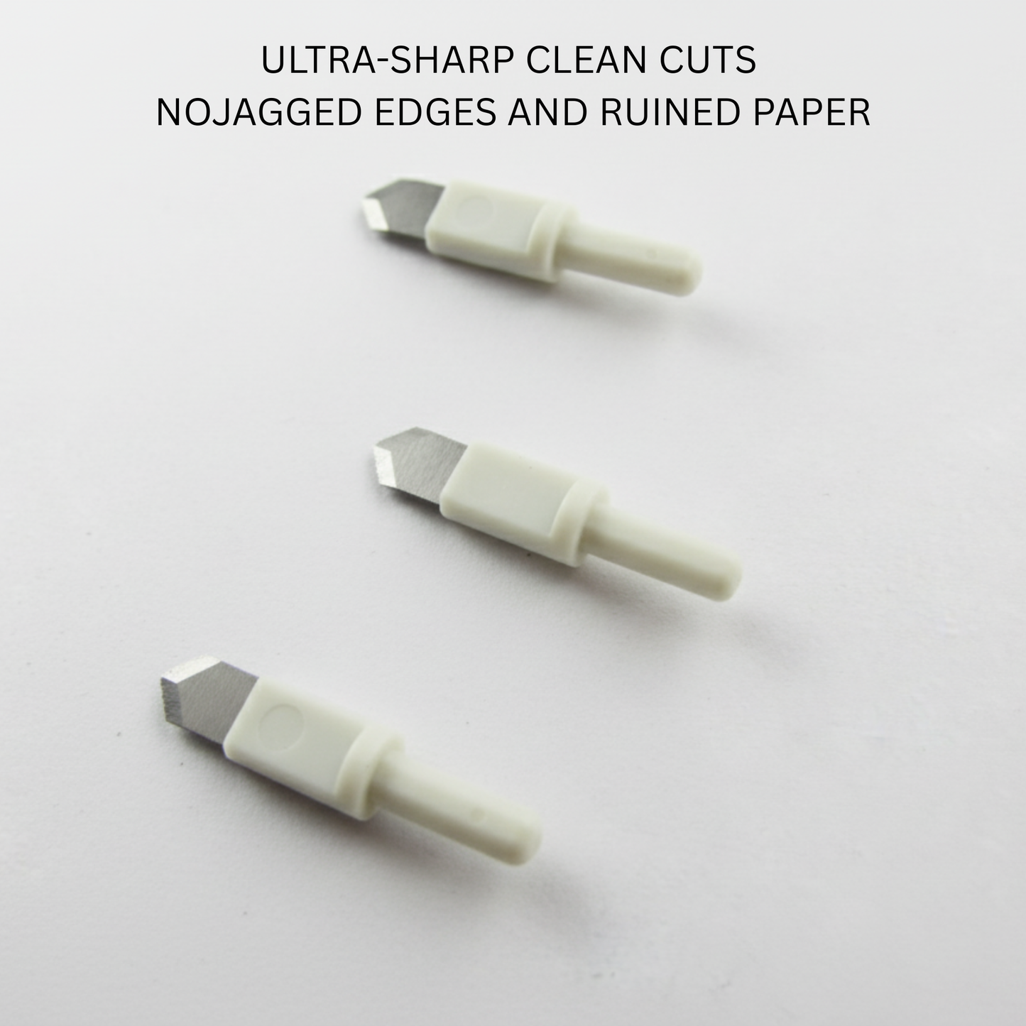 Three precision craft replacement knife tips displaying ultra-sharp bevel edges engineered for burr-free cardstock slicing.