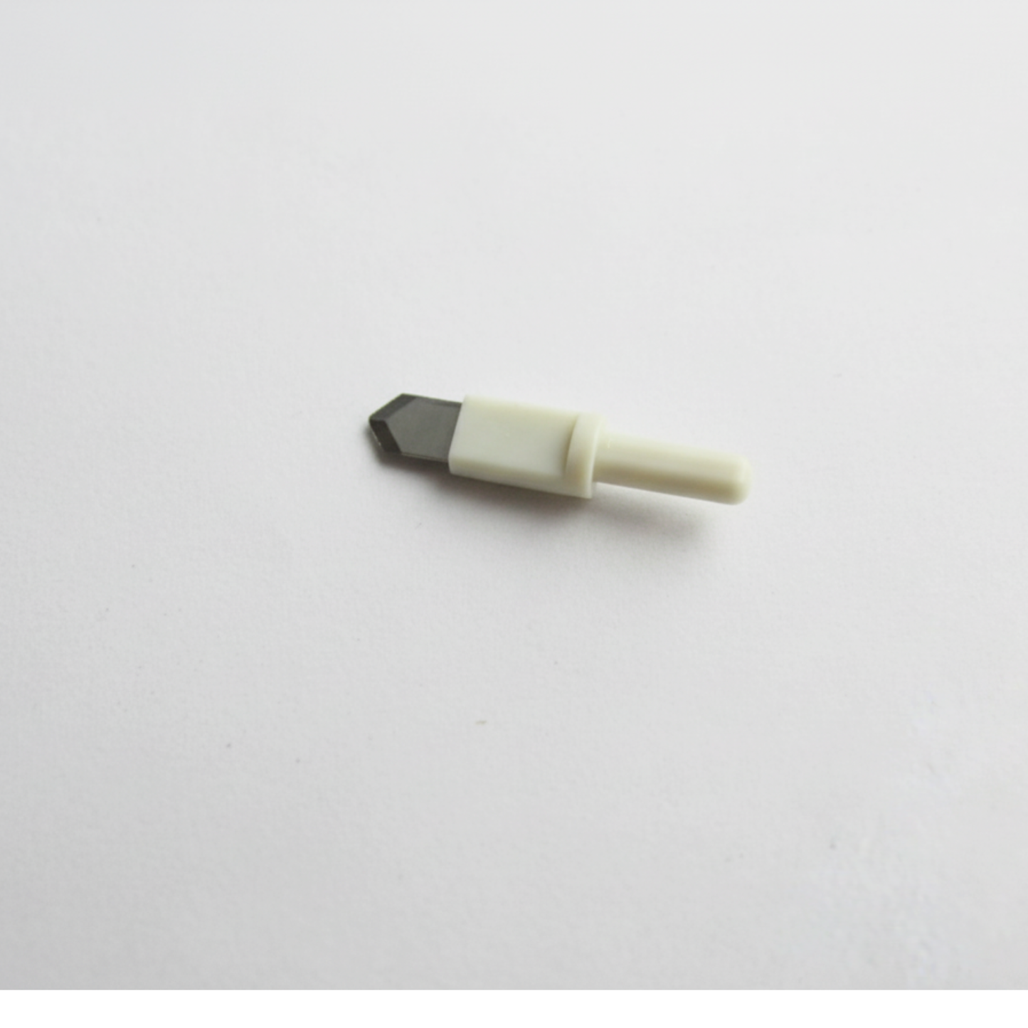 Close-up profile of a single heavy-duty replacement circle cutter blade displaying its secure plastic collet mount tip.