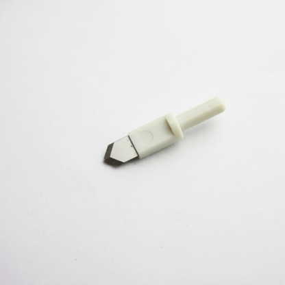 Macro shot showcasing the sharp steel point of an adjustable rotary circle trimmer replacement blade head.