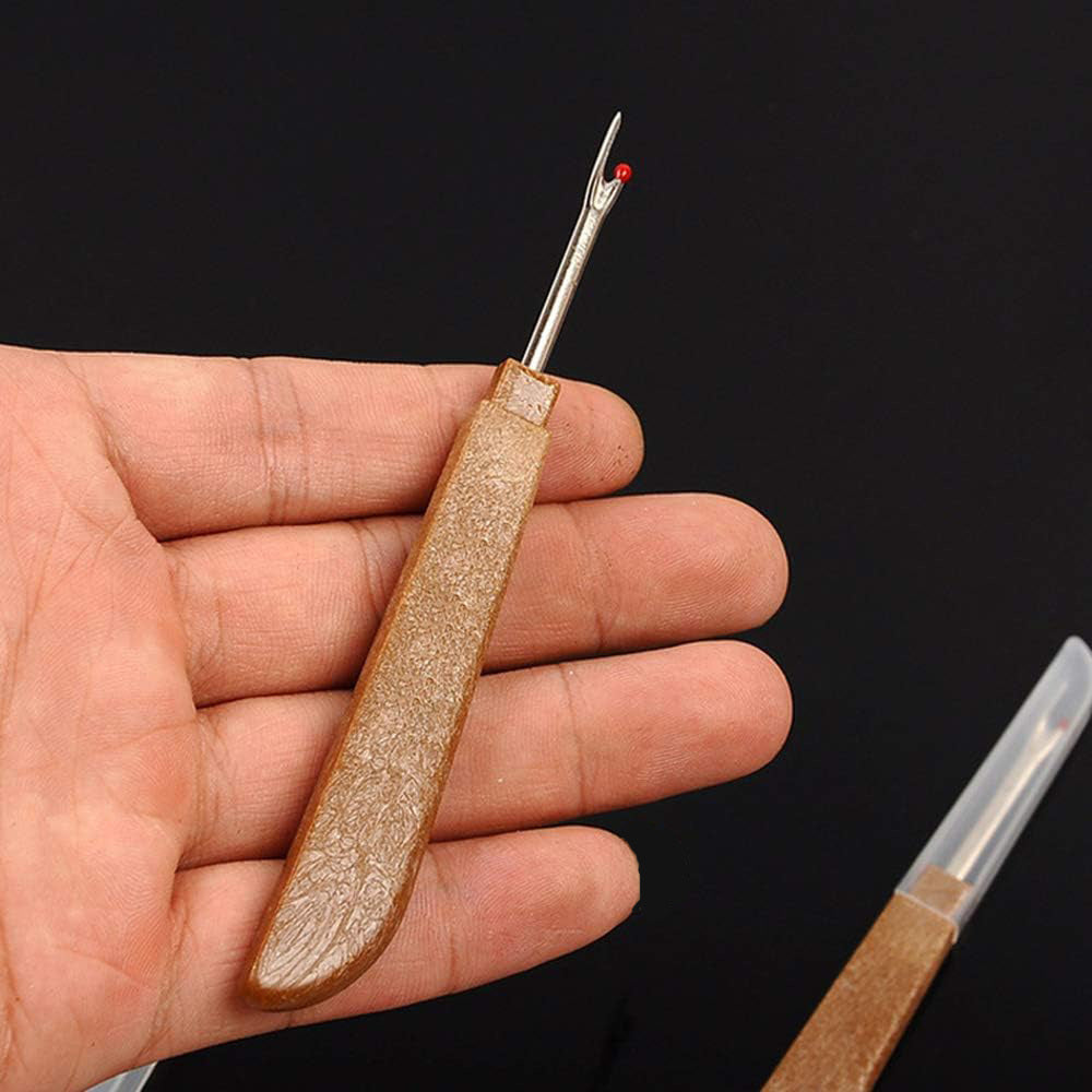 Hand holding a lightweight wood-style handle thread unpicker tool to showcase comfort and scale.