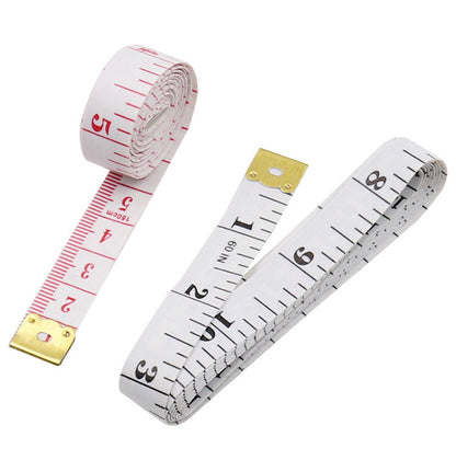 Two measuring tapes with gold ends on a white background