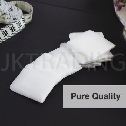 Pure quality white wax tailors crayon resting on dark cloth beside a flexible sewing tape measure.
