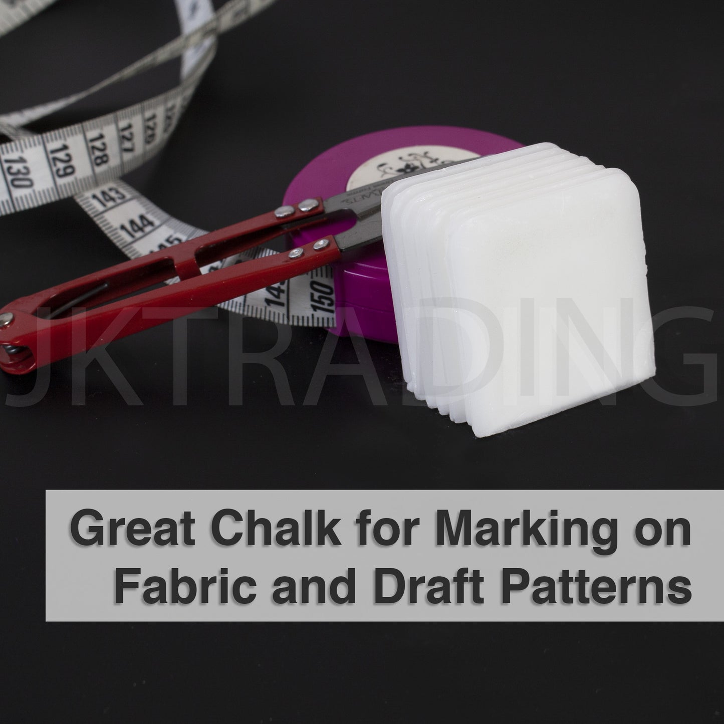 White heat-activated disappearing dressmaking chalk blocks paired with an apparel pattern tracing wheel.