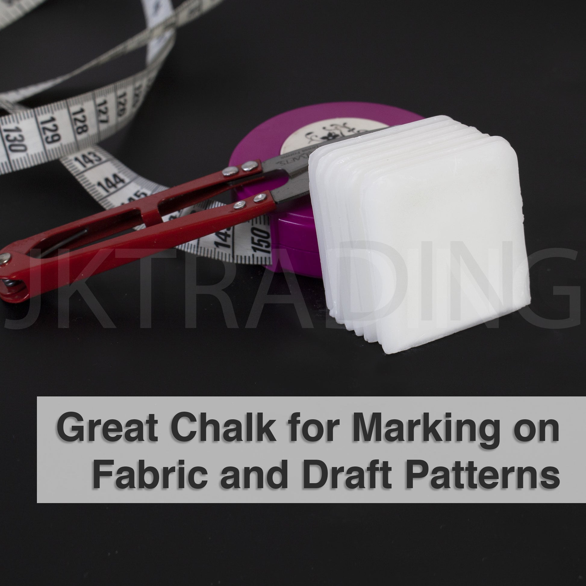 White heat-activated disappearing dressmaking chalk blocks paired with an apparel pattern tracing wheel.
