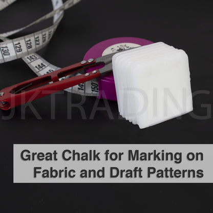 White heat-activated disappearing dressmaking chalk blocks paired with an apparel pattern tracing wheel.