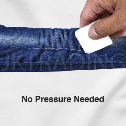 Hand holding a disappearing sewing wax block to lightly mark dark denim fabric without requiring downward pressure.