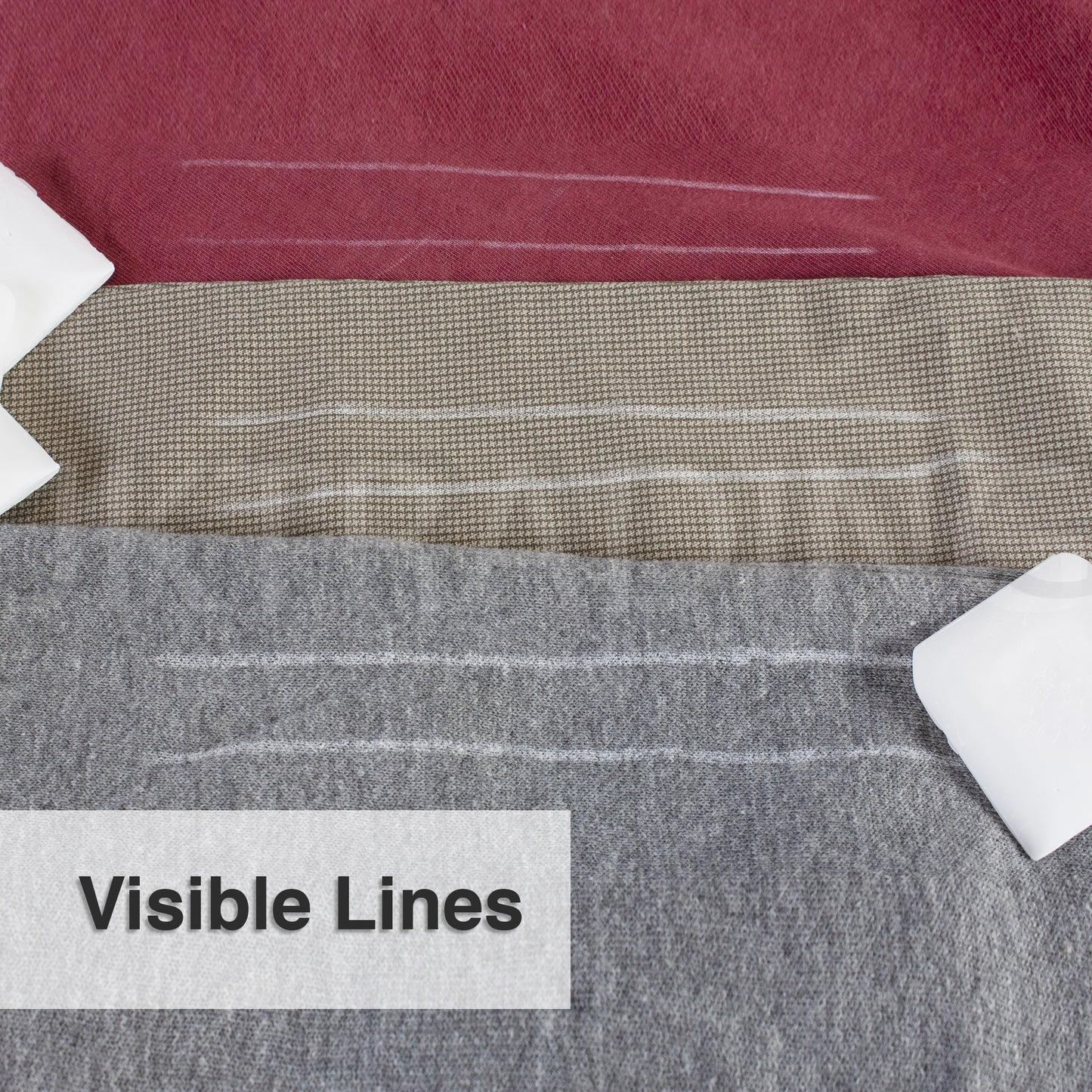 Clear, highly visible white pattern lines drawn onto textured grey wool clothing material using tailors wax.