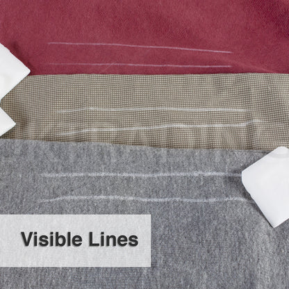 Clear, highly visible white pattern lines drawn onto textured grey wool clothing material using tailors wax.
