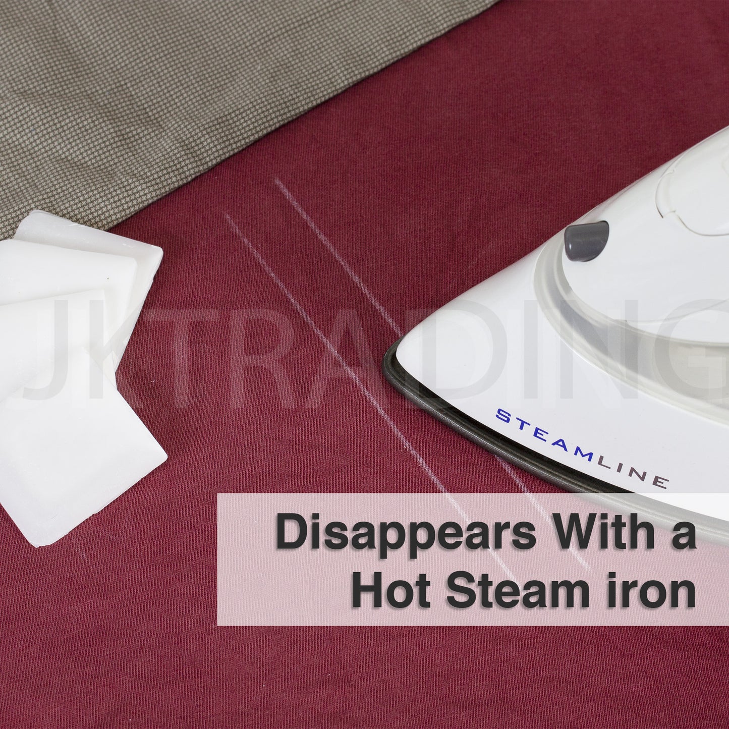 Hot steam iron pressing over fabric to demonstrate the clean heat-erasable disappearing feature of the wax lines.