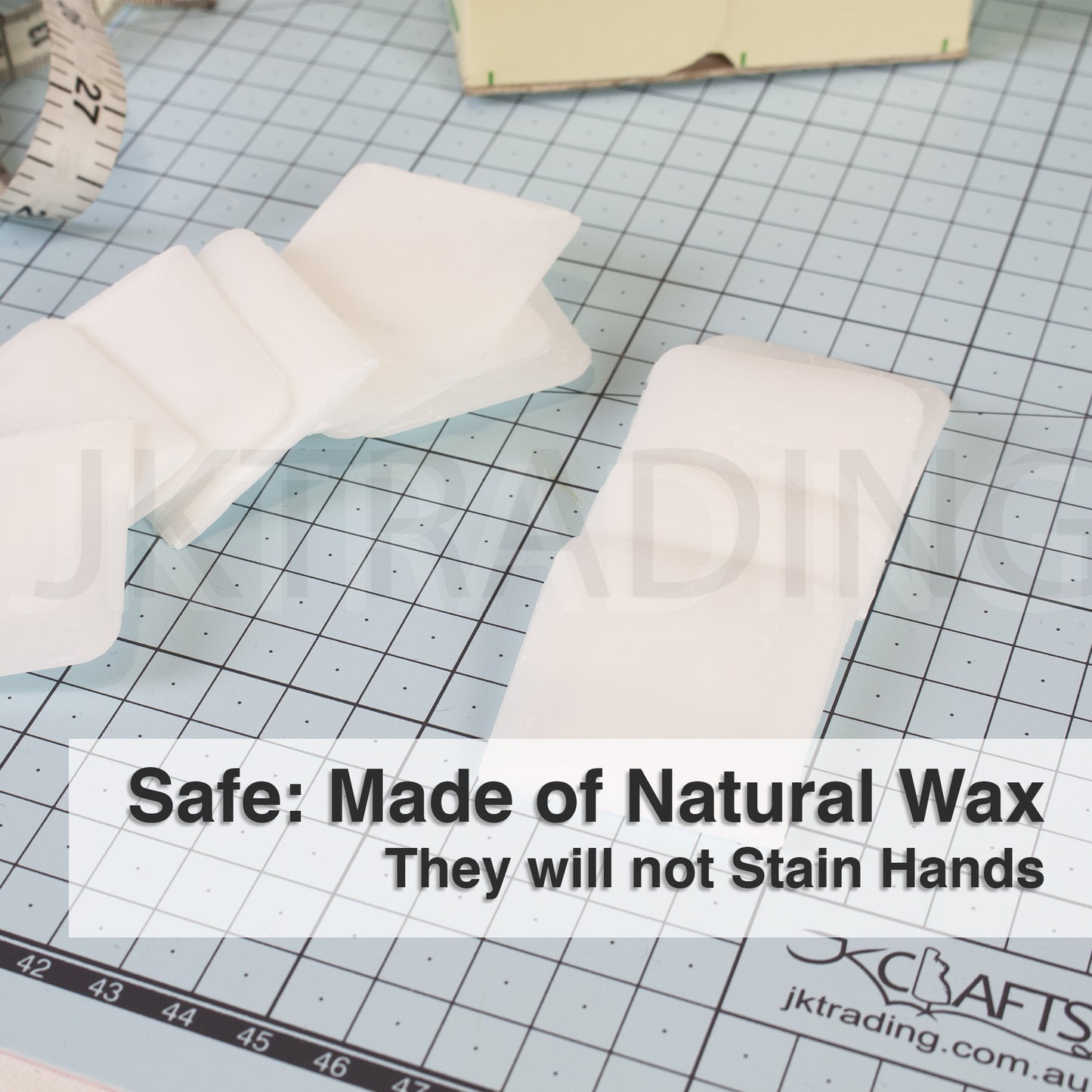 Non-staining square natural wax fabric markers arranged flat on a green professional cutting mat.