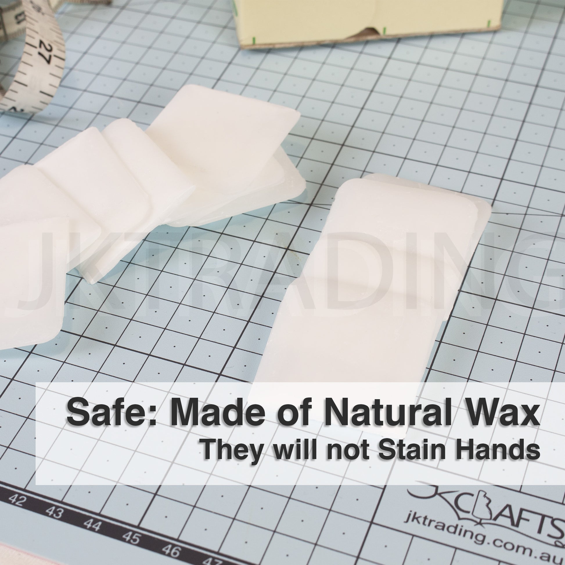 Non-staining square natural wax fabric markers arranged flat on a green professional cutting mat.