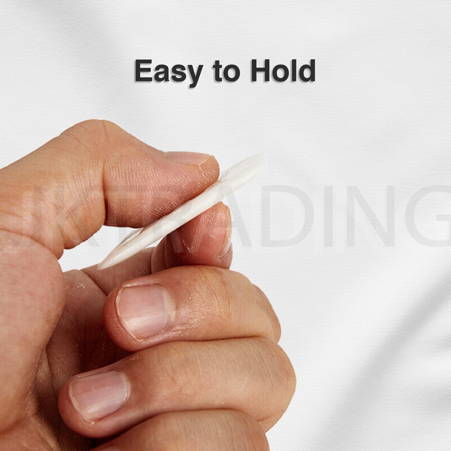 Side profile of a thin, ergonomic white wax chalk piece held in a hand to highlight its comfortable grip.
