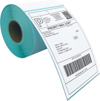 Roll of blank white self-adhesive direct thermal labels displaying a printed barcode sample text format.