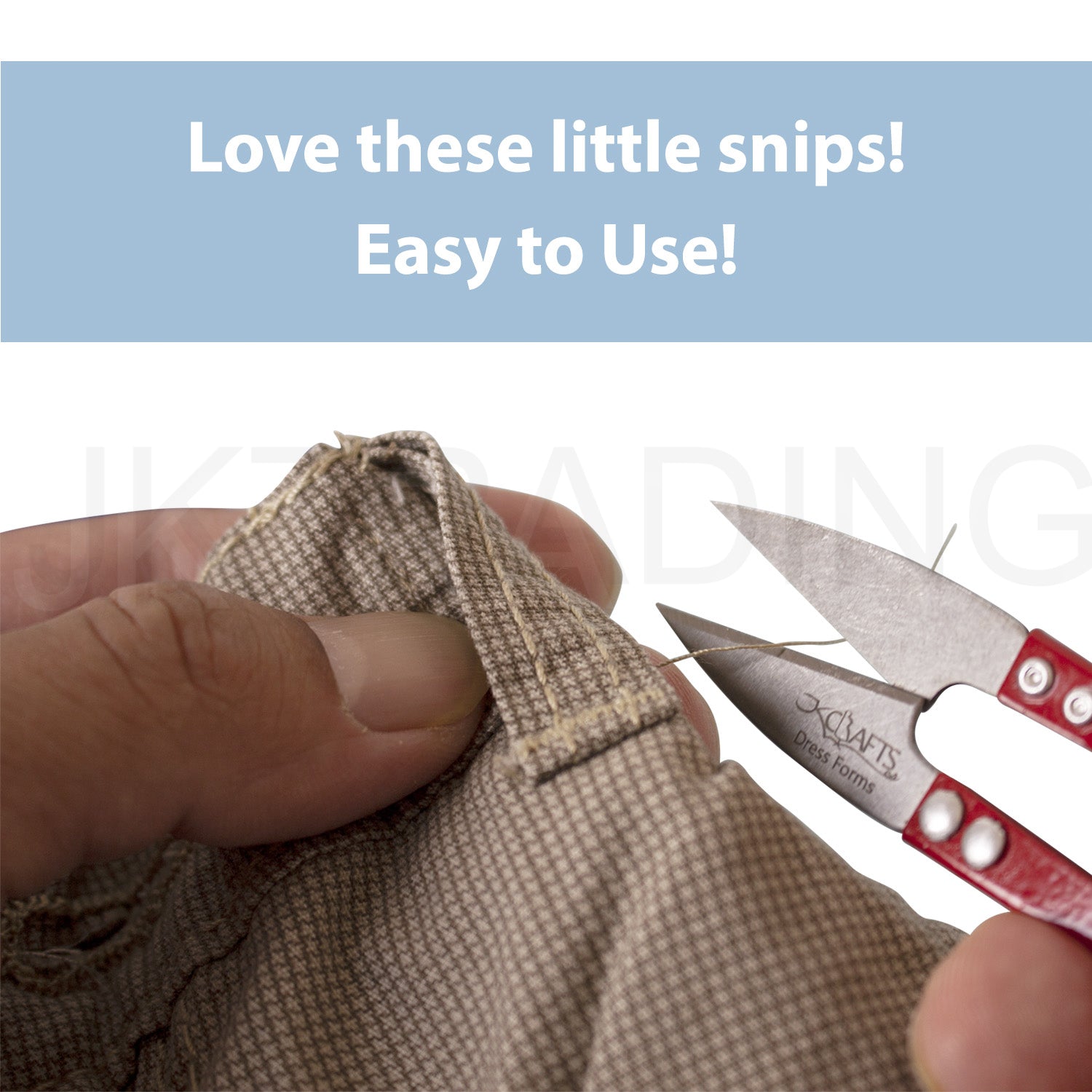 Hand operating red mini thread snips to cleanly trim loose yarn strands off a thick woven garment seam.
