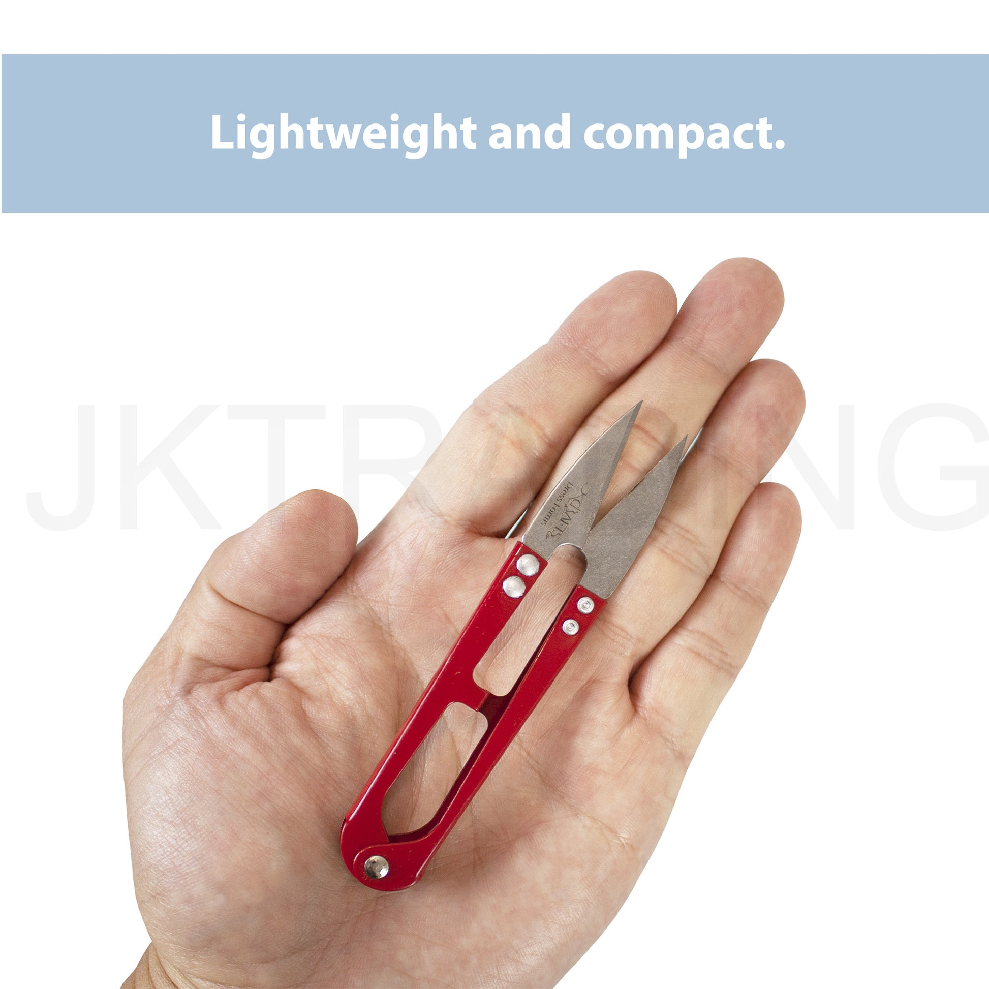 Open palm holding a compact red metal tailors thread nipper to showcase its lightweight, pocket-sized scale.