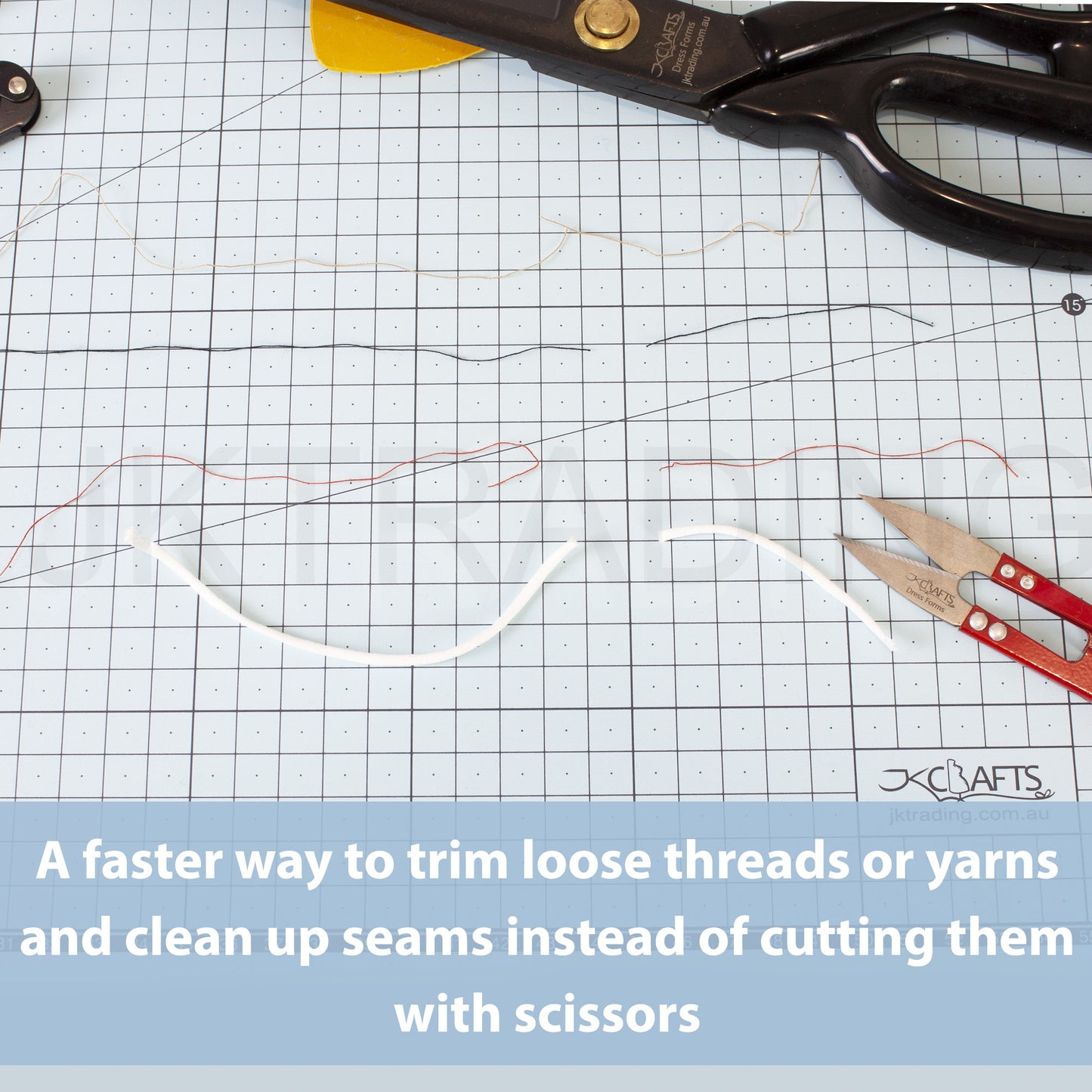 Red thread clippers resting on a green gridded self-healing cutting mat next to trimmed white rope yarn lines.