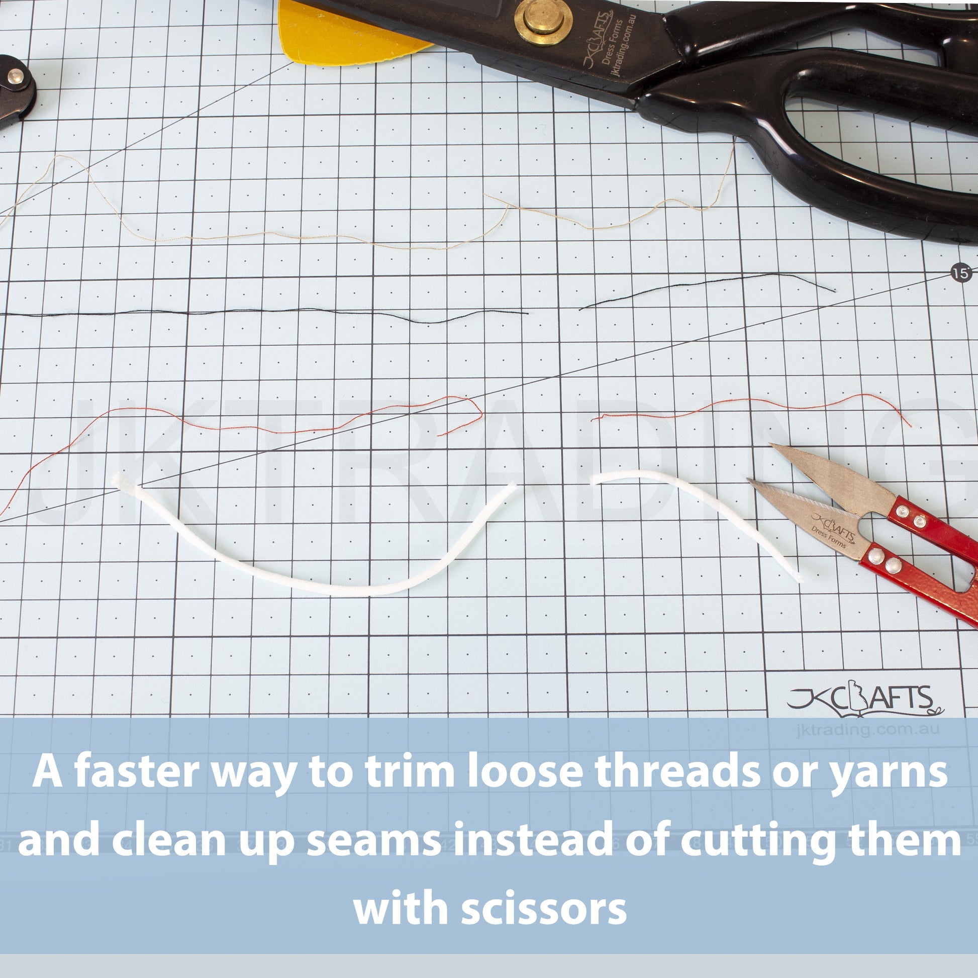 Red thread clippers resting on a green gridded self-healing cutting mat next to trimmed white rope yarn lines.