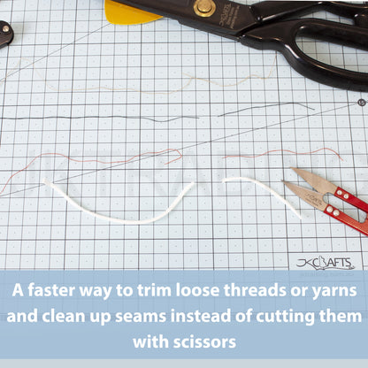 Red thread clippers resting on a green gridded self-healing cutting mat next to trimmed white rope yarn lines.