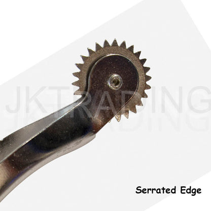 Close-up macro view of a circular steel serrated needle point gear wheel on a leather crafting tool.